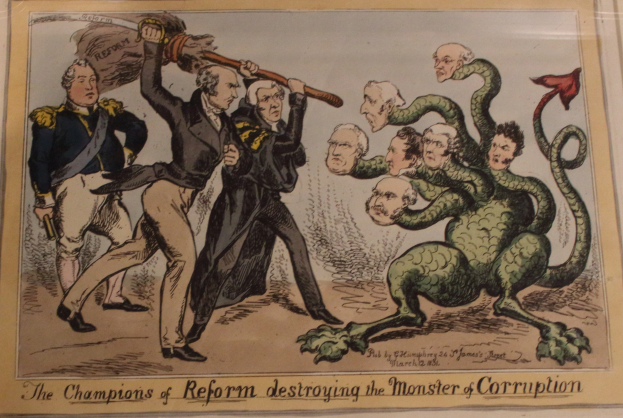 Eine Karikatur auf einem Blatt Papier, die Reformchampions bei der Bekämpfung eines Monsters namens "Korruption" zeigt, mit der Beschriftung "Die Reformchampions zerstören das Monster der Korruption."