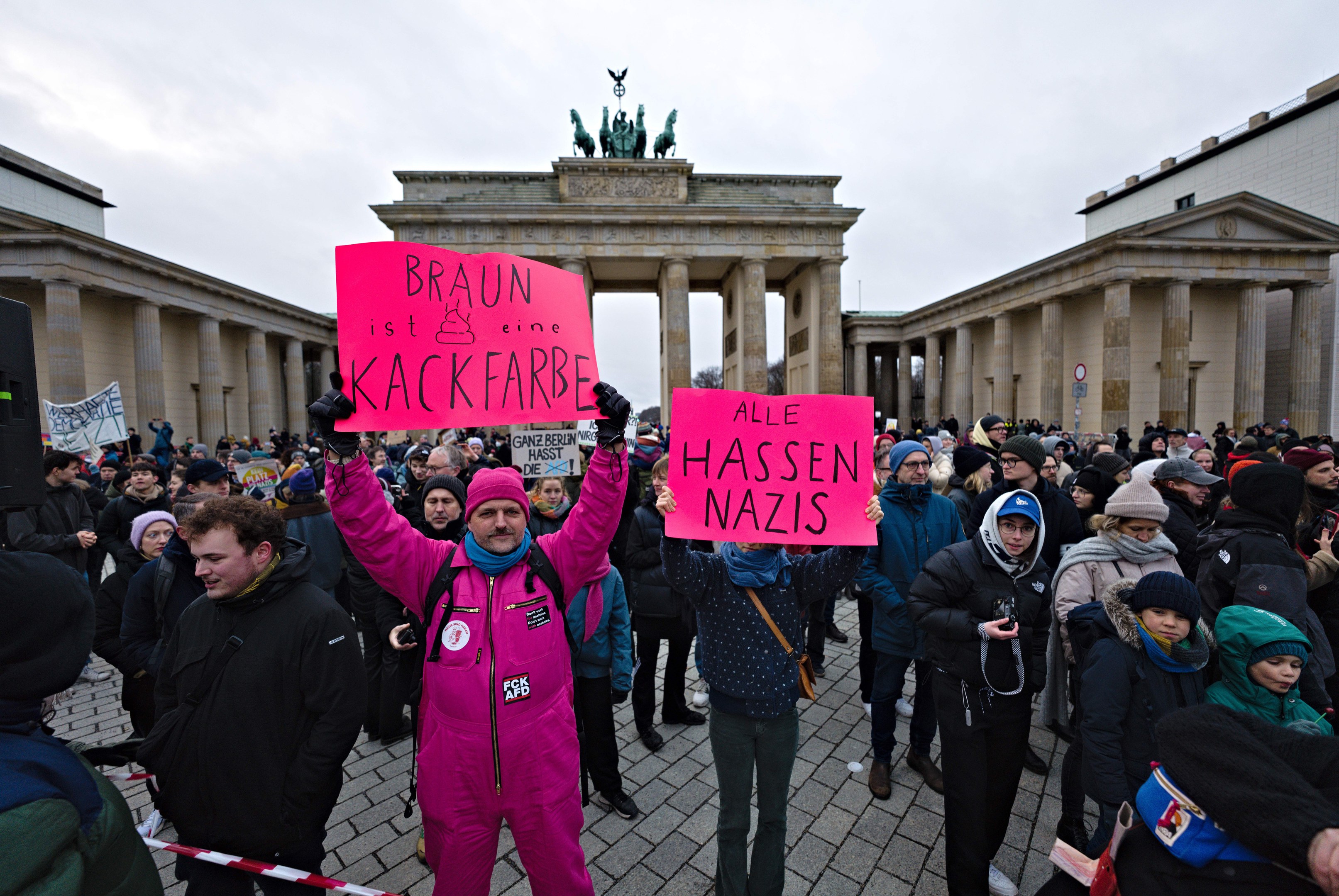 Gruppe von Menschen mit Schildern vor dem Reichstagsgebäude in Berlin, Deutschland, protestiert gegen die anti-nazistische Bewegung der deutschen Regierung.
