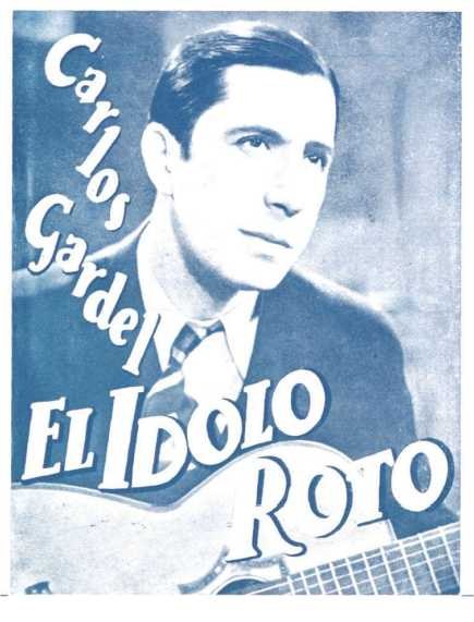 Plakat von El Idolo Roro, einem spanischen S├Ąnger-Songwriter, der eine Gitarre h├Ąlt, ein wei├čes Hemd und einen schwarzen Anzug tr├Ągt, mit zurückgek├Ąmmten Haaren und einem ernsten Gesichtsausdruck vor einem hellblauen Hintergrund.