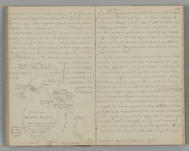 Ein offenes Journal mit handgeschriebenem Text und einer Karte auf seinen Seiten, das auf einer Oberfläche liegt.