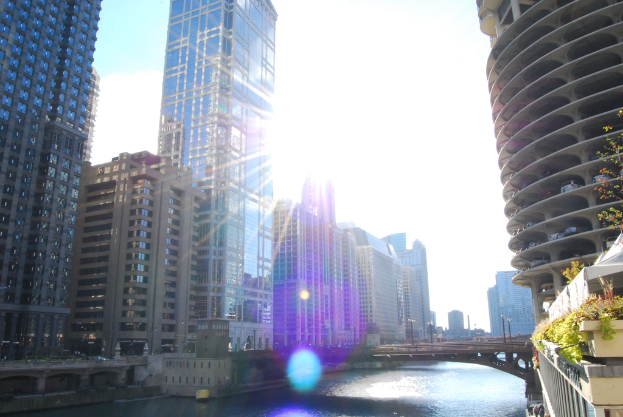 Ein See mit Gebäuden und Pflanzen auf beiden Seiten.