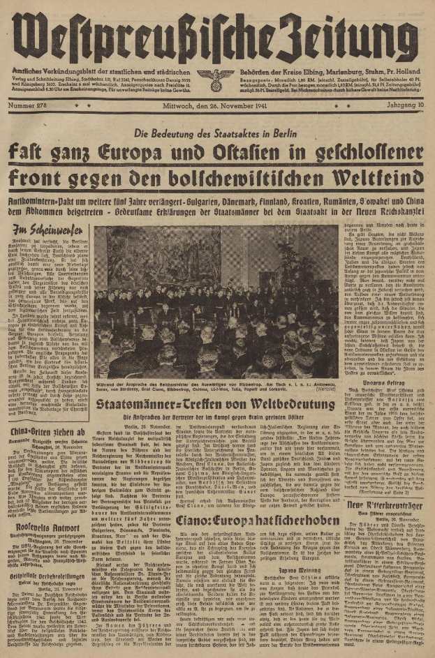 Zeitungsvorderseite mit der Schlagzeile "Weltpreubliche Zeitung" und einem zentralen Foto einer strahlenden, feiernden Gruppe vor einem hellgelben Hintergrund.